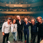 Jason Isbell and the 400 Unit on Stage with crowd behind them